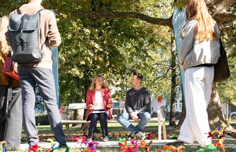 Caritasdirektorin Nora Tödtling-Musenbichler am 'Plauderbankerl' / Caritas Steiermark, Streif Schülerinnen und Schüler der HLW Sozialmanagement schmücken das Plauderbankerl am Aktionstag mit Blumen