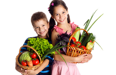 Smiling kids with fresh vegetables in baskets, isolated on white